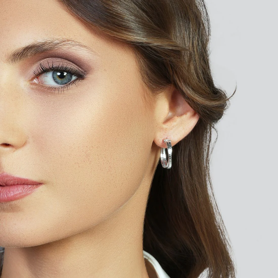 Orecchini Unoaerre semicerchio fili intrecciati finitura rigata 6673