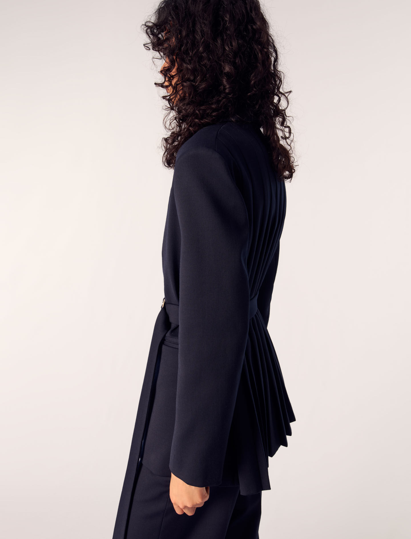 Suit jacket with pleated back