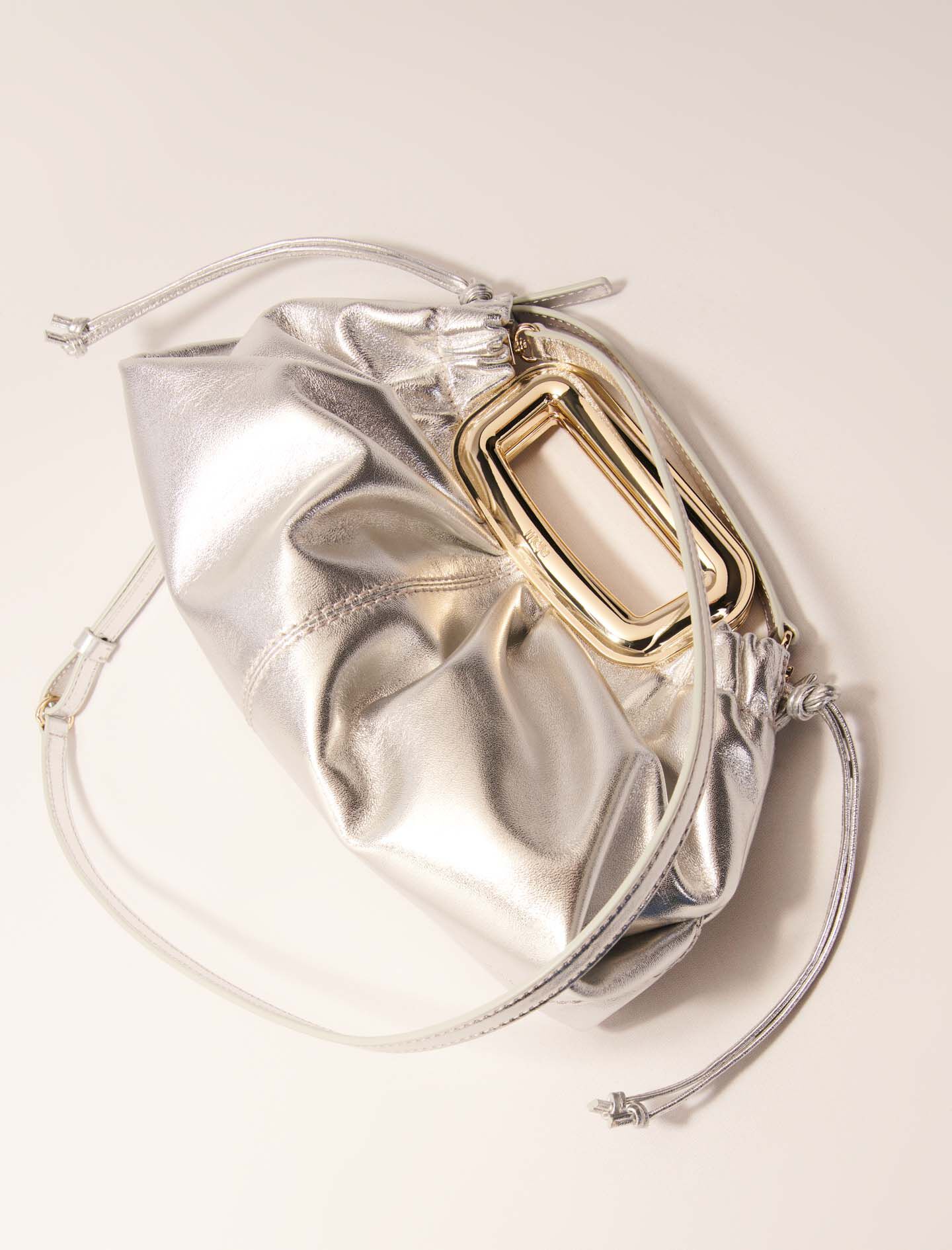 Metal handle leather clutch