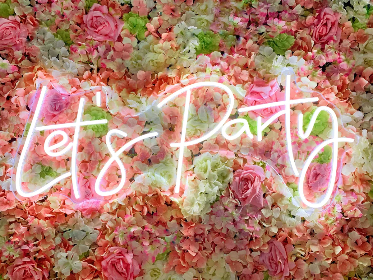 Neon “LET’S PARTY” sign in cool white