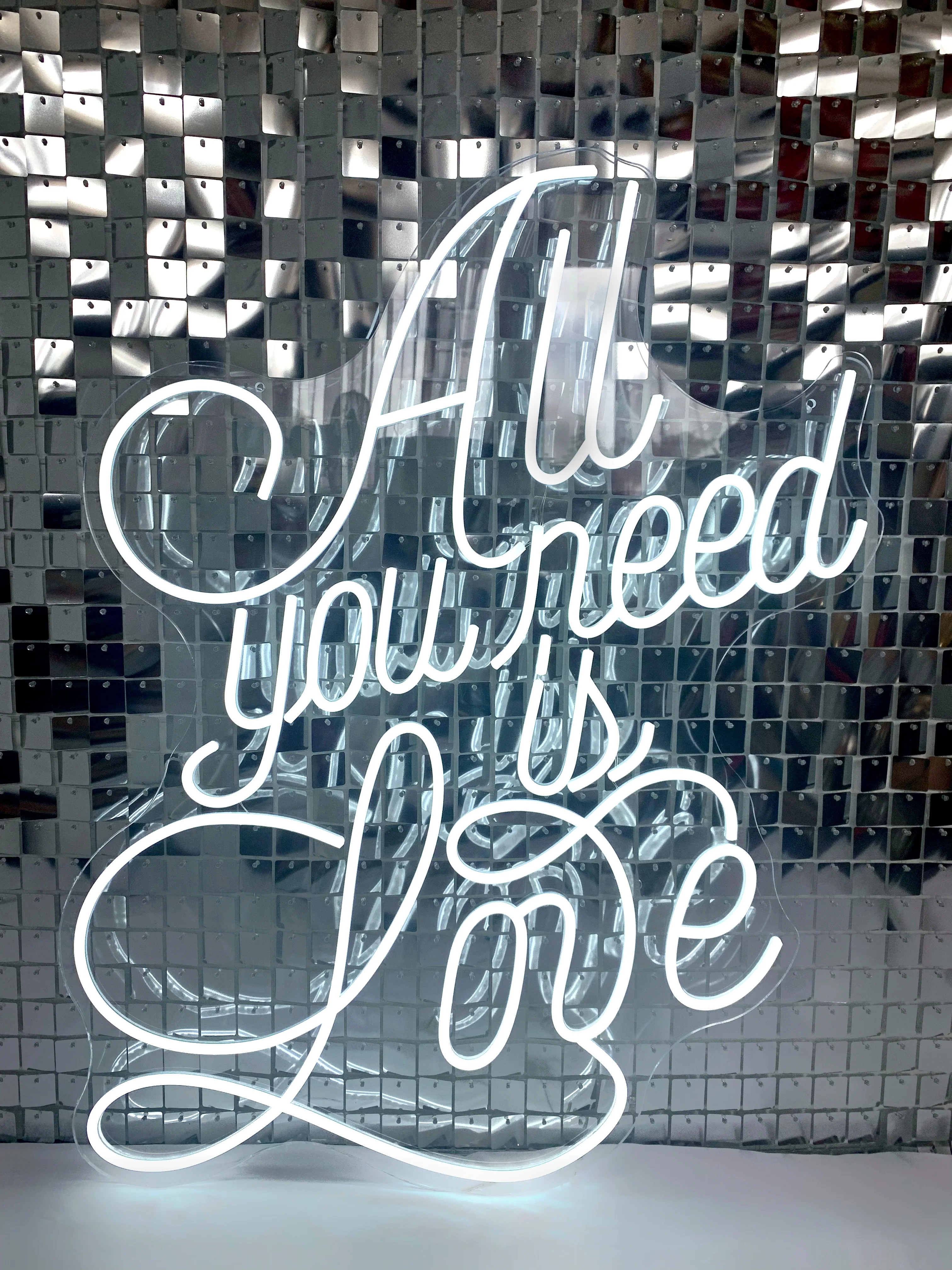 “All you need is love” neon sign in cool white